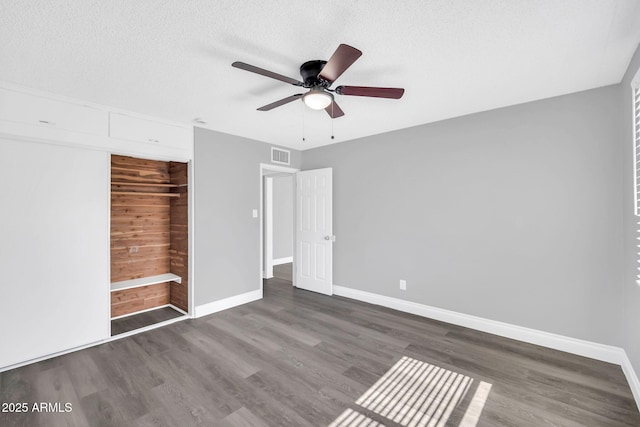 7039 N 15th St, Phoenix, AZ 85020 - unfurnished bedroom with a textured ceiling, a ceiling fan, visible vents, wood finished floors, and baseboards