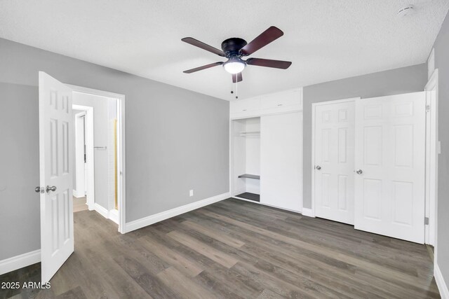 7039 N 15th St, Phoenix, AZ 85020 - unfurnished bedroom with ceiling fan, baseboards, and dark wood finished floors