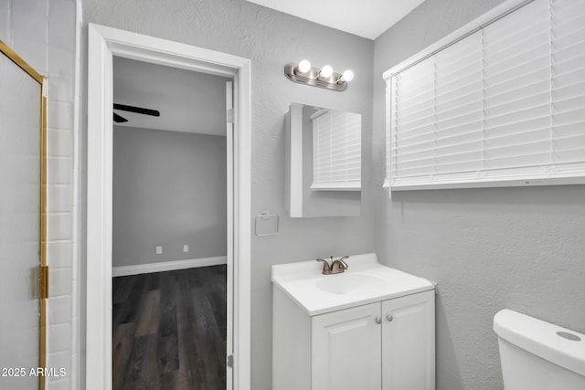 7039 N 15th St, Phoenix, AZ 85020 - full bathroom with vanity, baseboards, an enclosed shower, toilet, and wood finished floors