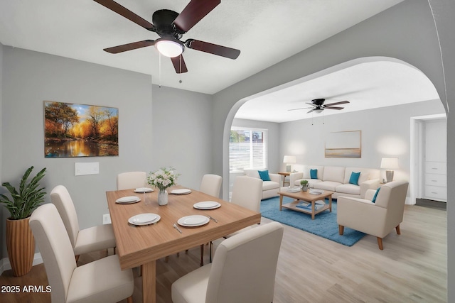 7039 N 15th St, Phoenix, AZ 85020 - dining room with arched walkways, light wood-style flooring, and a ceiling fan