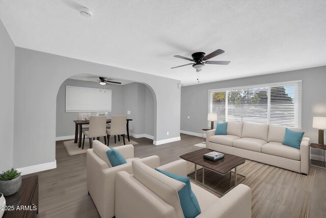 7039 N 15th St, Phoenix, AZ 85020 - living area with baseboards, a ceiling fan, arched walkways, and wood finished floors