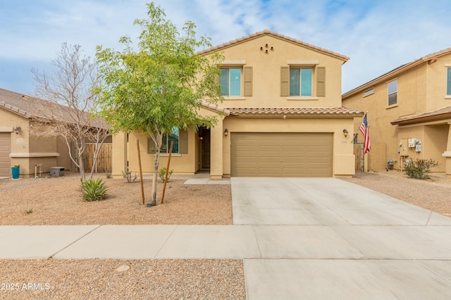 mediterranean / spanish-style house featuring a garage, a tile roof, concrete driveway, and stucco siding