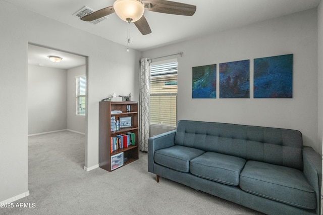 sitting room with carpet, ceiling fan, and baseboards