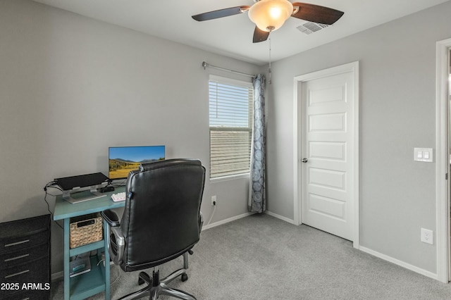 carpeted office space with baseboards, visible vents, and ceiling fan