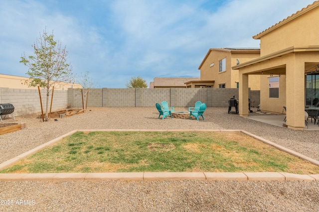 view of yard with a patio, an outdoor fire pit, and a fenced backyard