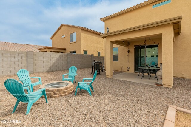 view of patio with an outdoor fire pit, a fenced backyard, and grilling area