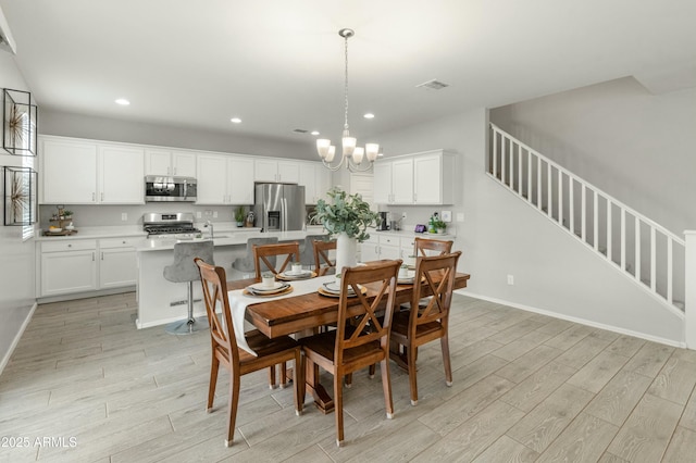 dining space with baseboards, light wood-style flooring, stairs, a notable chandelier, and recessed lighting