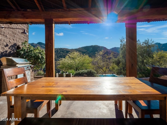 exterior space featuring a mountain view and a grill