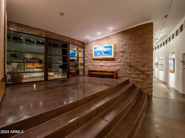 interior space featuring concrete flooring and vaulted ceiling