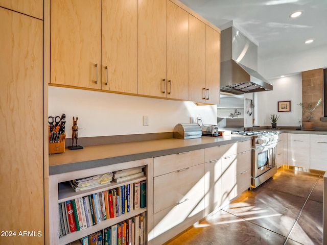 kitchen featuring light brown cabinets, stainless steel range, and exhaust hood