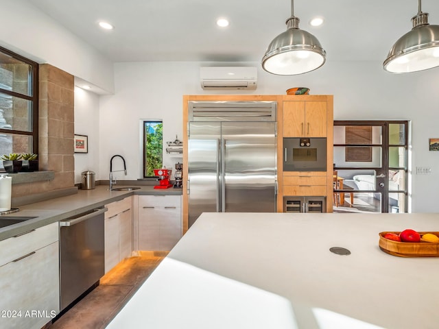 kitchen featuring pendant lighting, appliances with stainless steel finishes, a wall unit AC, and plenty of natural light