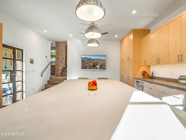 kitchen featuring light brown cabinetry and wine cooler