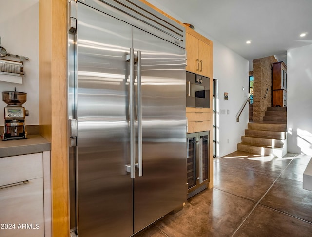 kitchen featuring wine cooler, stainless steel built in refrigerator, and light brown cabinets