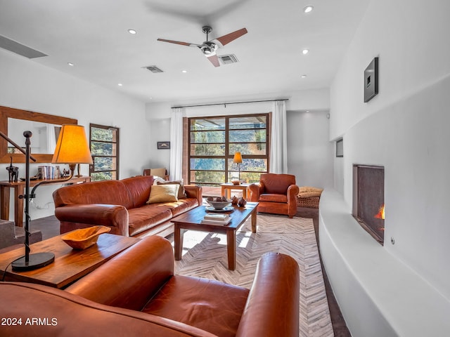 living room featuring light parquet flooring and ceiling fan