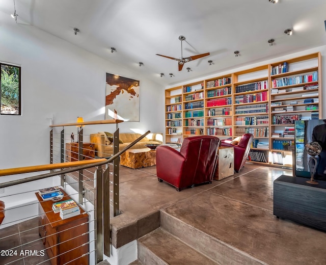 interior space with concrete flooring and ceiling fan