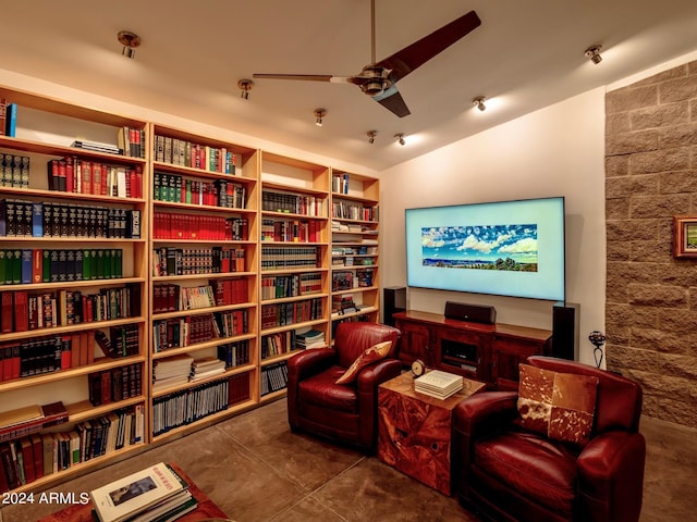 sitting room with ceiling fan and lofted ceiling