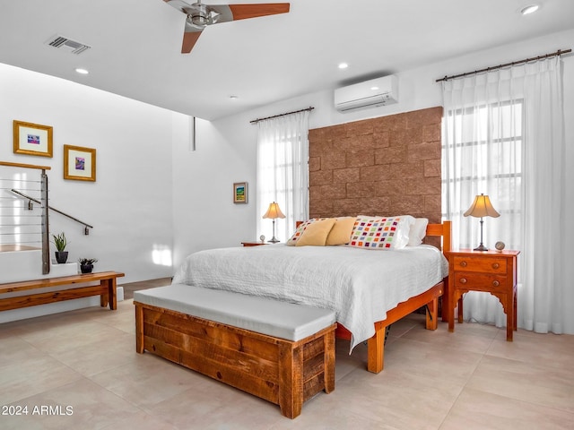 bedroom with ceiling fan and an AC wall unit