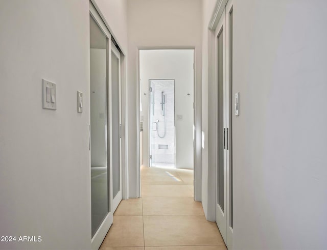 hall with light tile patterned floors