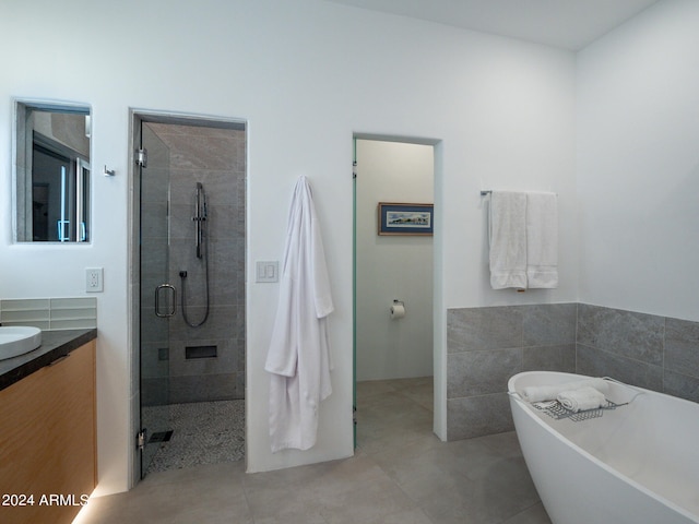 bathroom featuring vanity and independent shower and bath