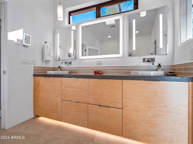 bathroom with vanity, tile patterned floors, and a healthy amount of sunlight