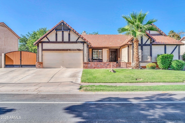6708 W Utopia Rd, Glendale, AZ 85308 - tudor-style house featuring a gate, an attached garage, driveway, a front lawn, and stucco siding