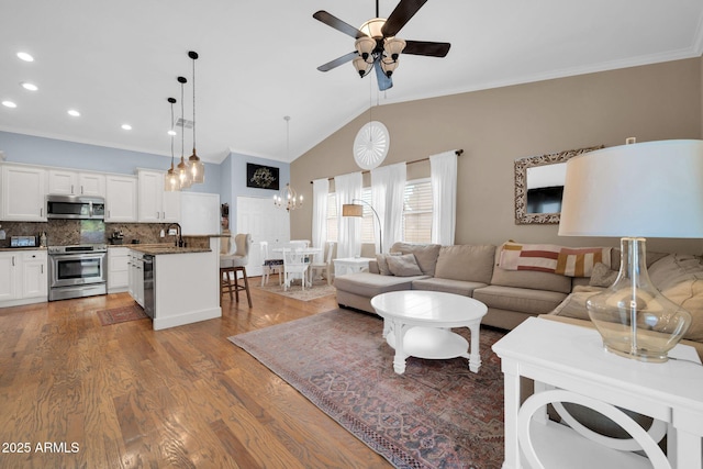 6708 W Utopia Rd, Glendale, AZ 85308 - living room featuring crown molding, a ceiling fan, a chandelier, wood finished floors, and recessed lighting