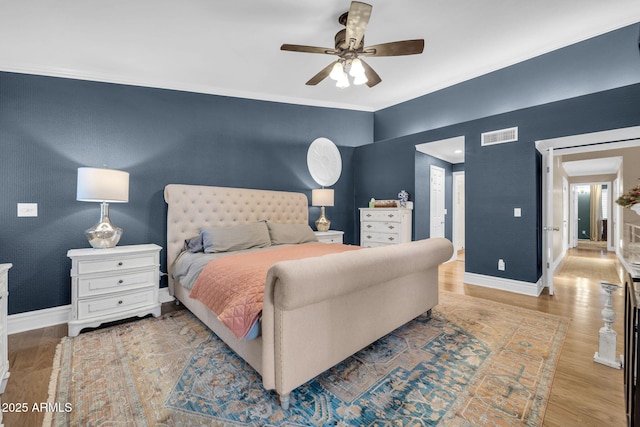 6708 W Utopia Rd, Glendale, AZ 85308 - bedroom with wood finished floors, crown molding, and a ceiling fan