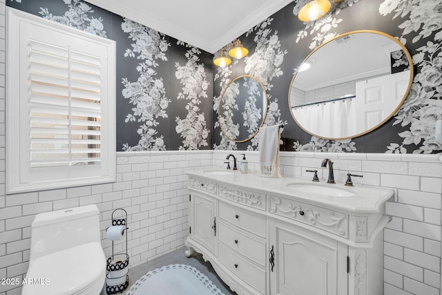 6708 W Utopia Rd, Glendale, AZ 85308 - full bathroom featuring tile walls, crown molding, double vanity, wallpapered walls, and wainscoting