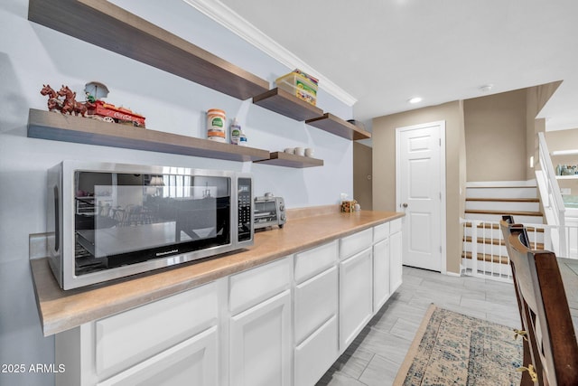 6708 W Utopia Rd, Glendale, AZ 85308 - kitchen featuring stainless steel microwave, open shelves, white cabinets, light countertops, and recessed lighting