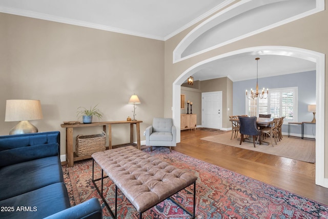 6708 W Utopia Rd, Glendale, AZ 85308 - living room with arched walkways, wood finished floors, a chandelier, and ornamental molding