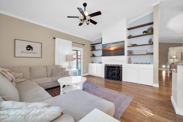 6708 W Utopia Rd, Glendale, AZ 85308 - living room with ceiling fan, vaulted ceiling, wood finished floors, crown molding, and a fireplace