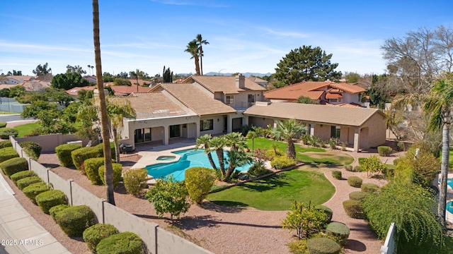 view of pool featuring a fenced in pool, a lawn, a fenced backyard, a residential view, and a patio area