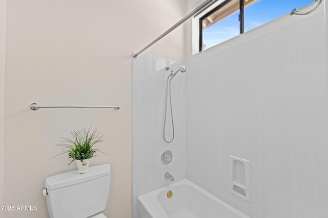 bathroom featuring shower / bath combination and toilet