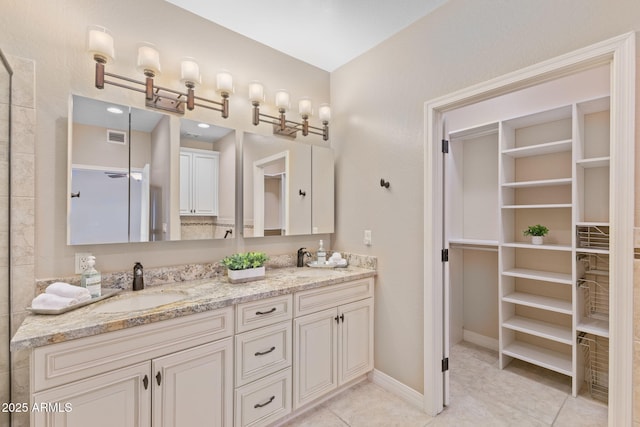 full bath featuring tile patterned flooring, visible vents, a sink, and double vanity