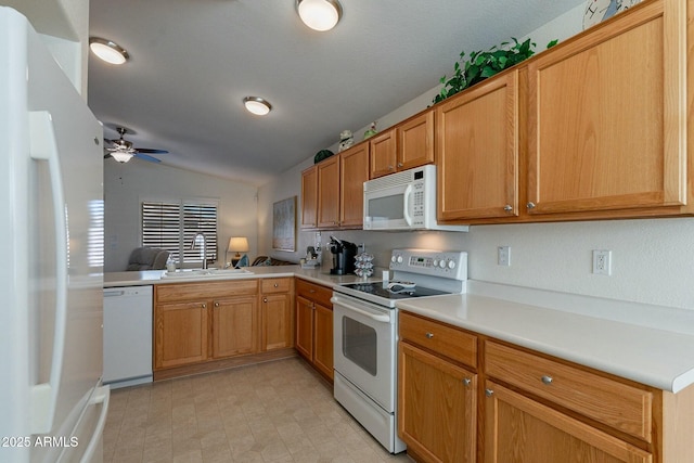 kitchen featuring ceiling fan, sink, kitchen peninsula, lofted ceiling, and white appliances