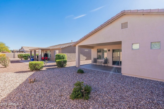 rear view of house featuring a patio