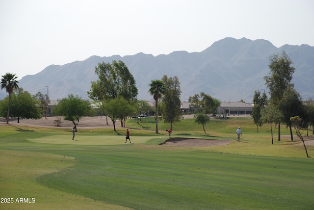 view of community featuring a mountain view and a lawn