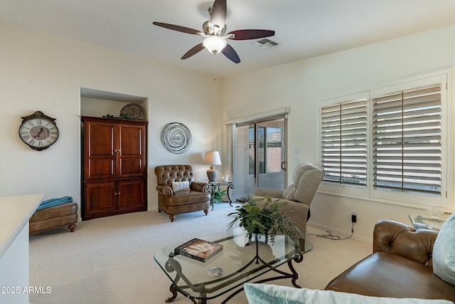 carpeted living room with ceiling fan