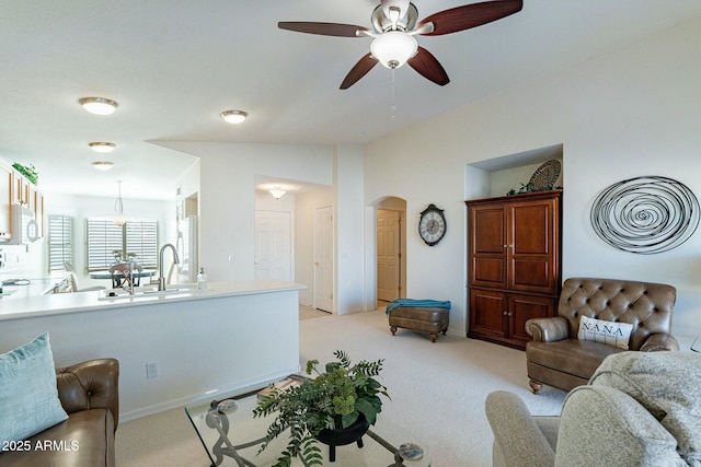 carpeted living room featuring ceiling fan and lofted ceiling