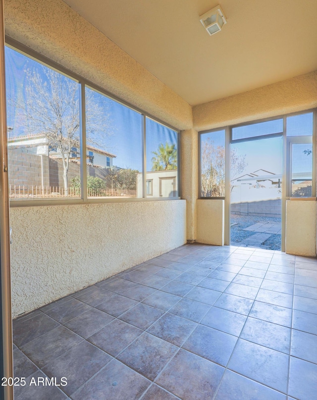 unfurnished sunroom with a wealth of natural light