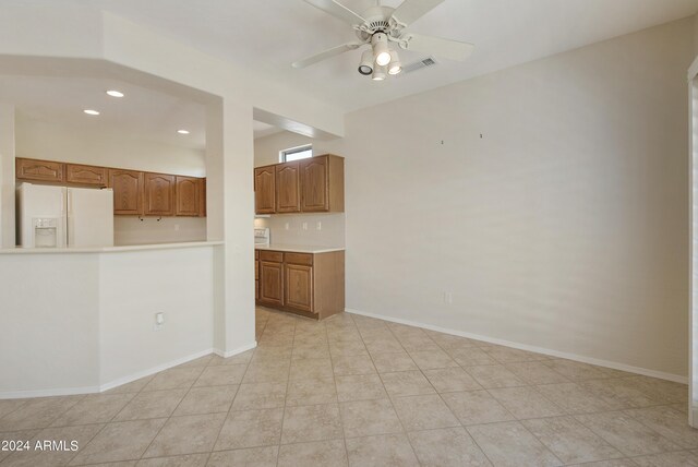 unfurnished living room featuring ceiling fan and light tile patterned floors