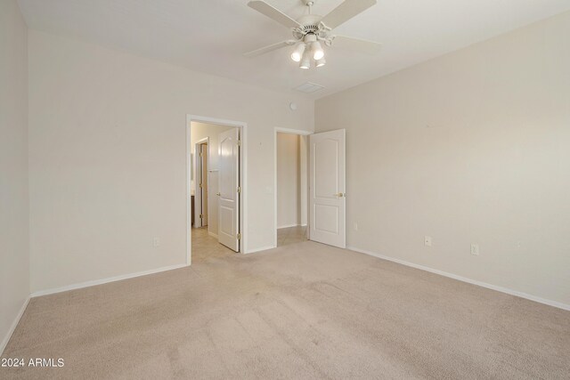 unfurnished bedroom with ceiling fan and light carpet