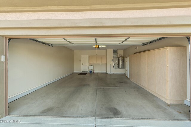 garage featuring a garage door opener and electric water heater