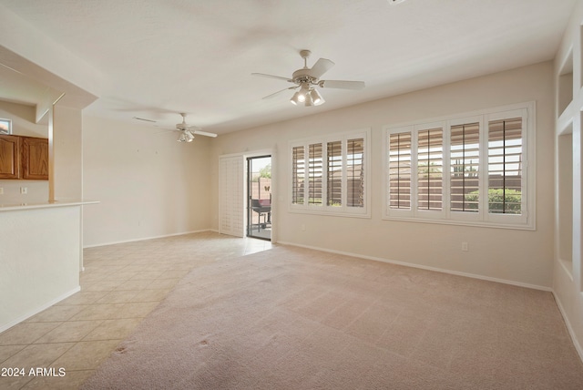 unfurnished living room featuring ceiling fan and light tile patterned floors