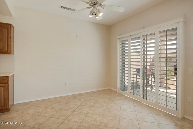 unfurnished dining area with ceiling fan, light tile patterned flooring, and plenty of natural light