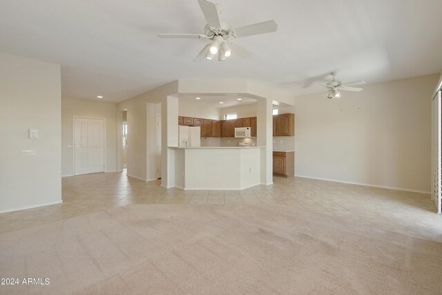 unfurnished living room with ceiling fan and light tile patterned floors