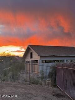 property exterior at dusk with fence