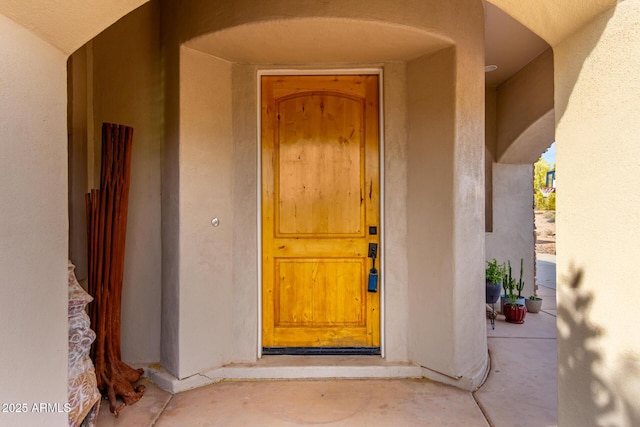 doorway to property with stucco siding