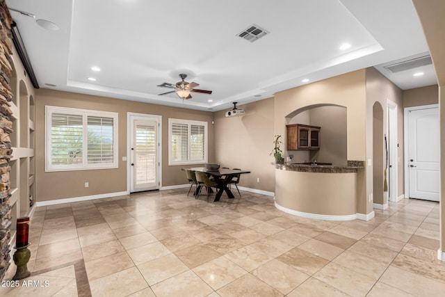 entryway with visible vents, baseboards, ceiling fan, recessed lighting, and a tray ceiling