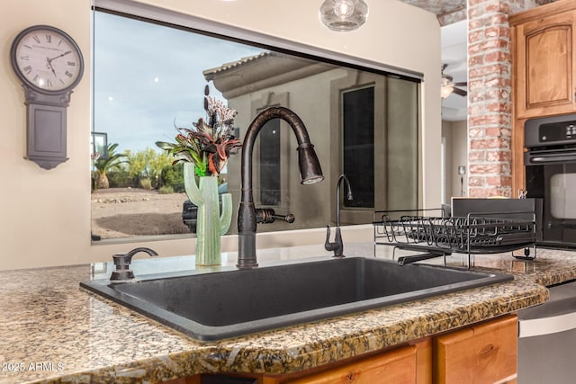 details with a sink, ceiling fan, black oven, and dishwasher